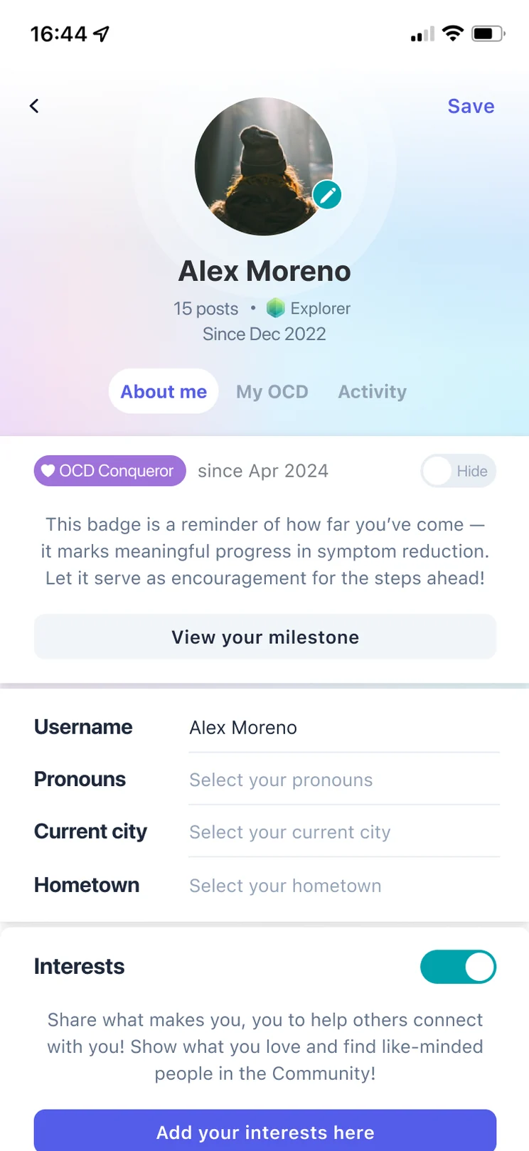 The redesigned profile: under the name, an OCD Conqueror badge since April 2024 with a Hide toggle, a short note on what the badge marks, and a View your milestone button.